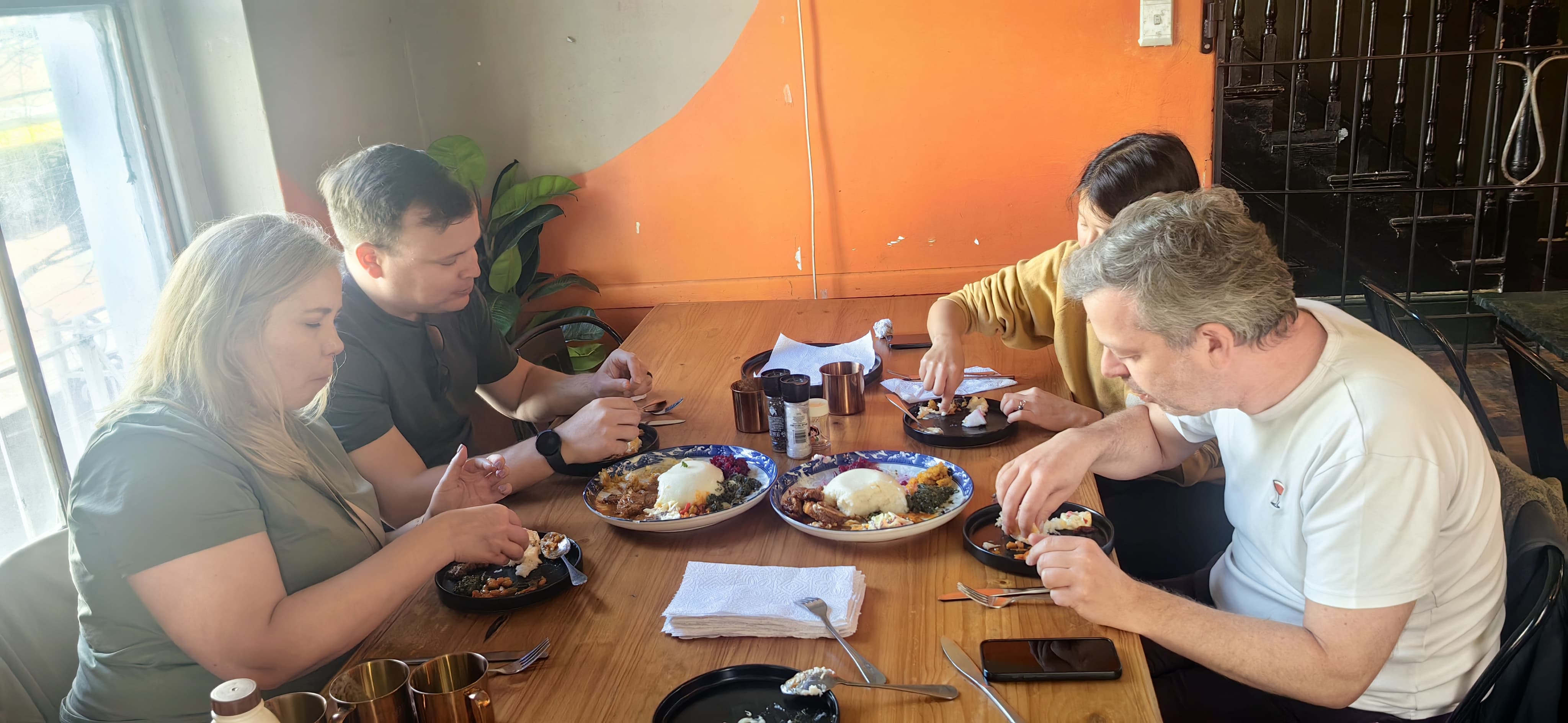 Guests sharing a traditional South African meal at a Cape Town township restaurant