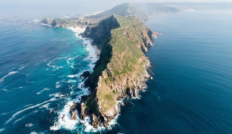 Dramatic aerial view of the Cape Point peninsula meeting the Atlantic and Indian Oceans, South Africa